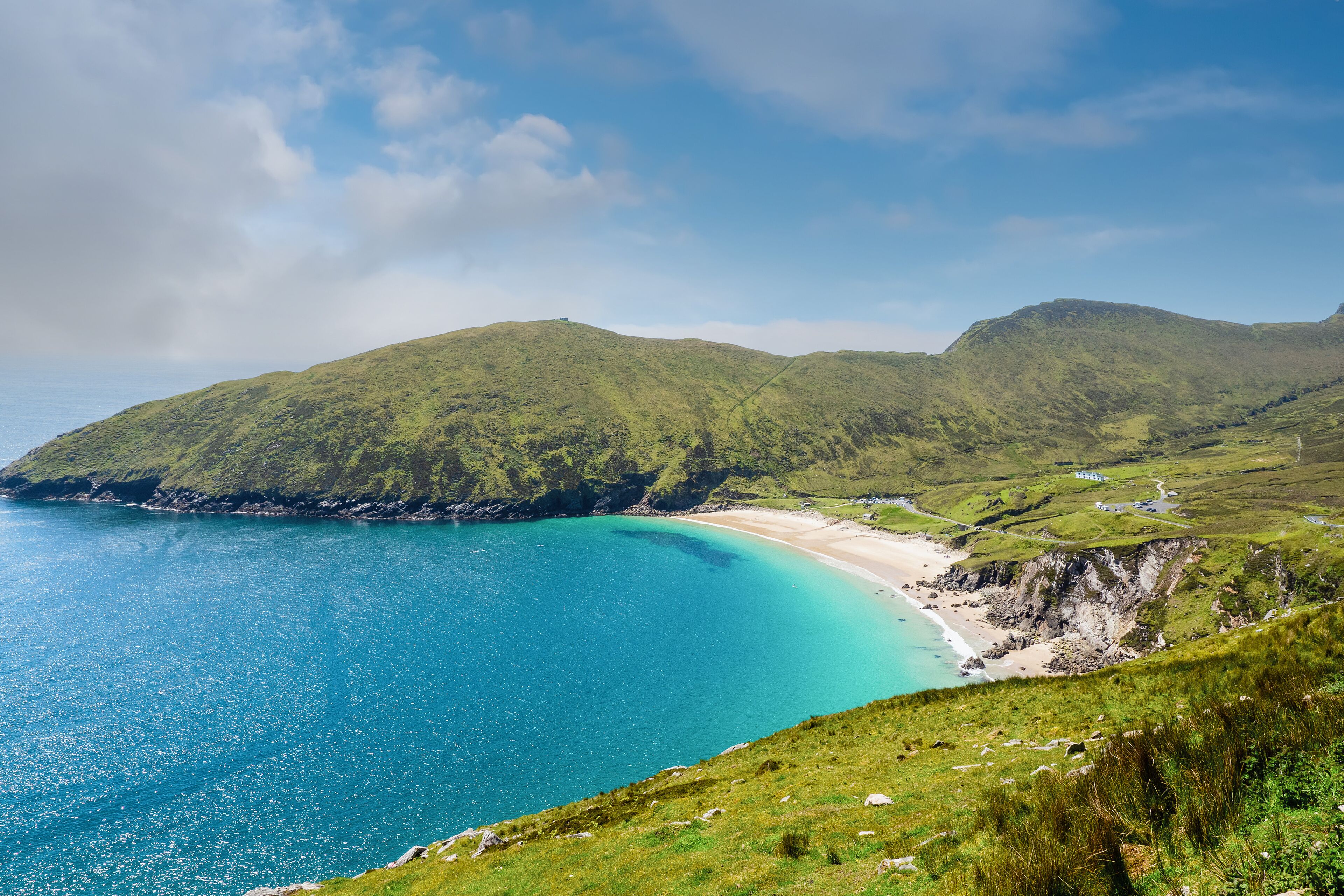 Keem beach, Achill island in county Mayo, Ireland, warm sunny day. Clear blue sky and water of the Atlantic ocean.