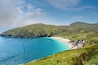 Keem beach, Achill island in county Mayo, Ireland, warm sunny day. Clear blue sky and water of the Atlantic ocean.