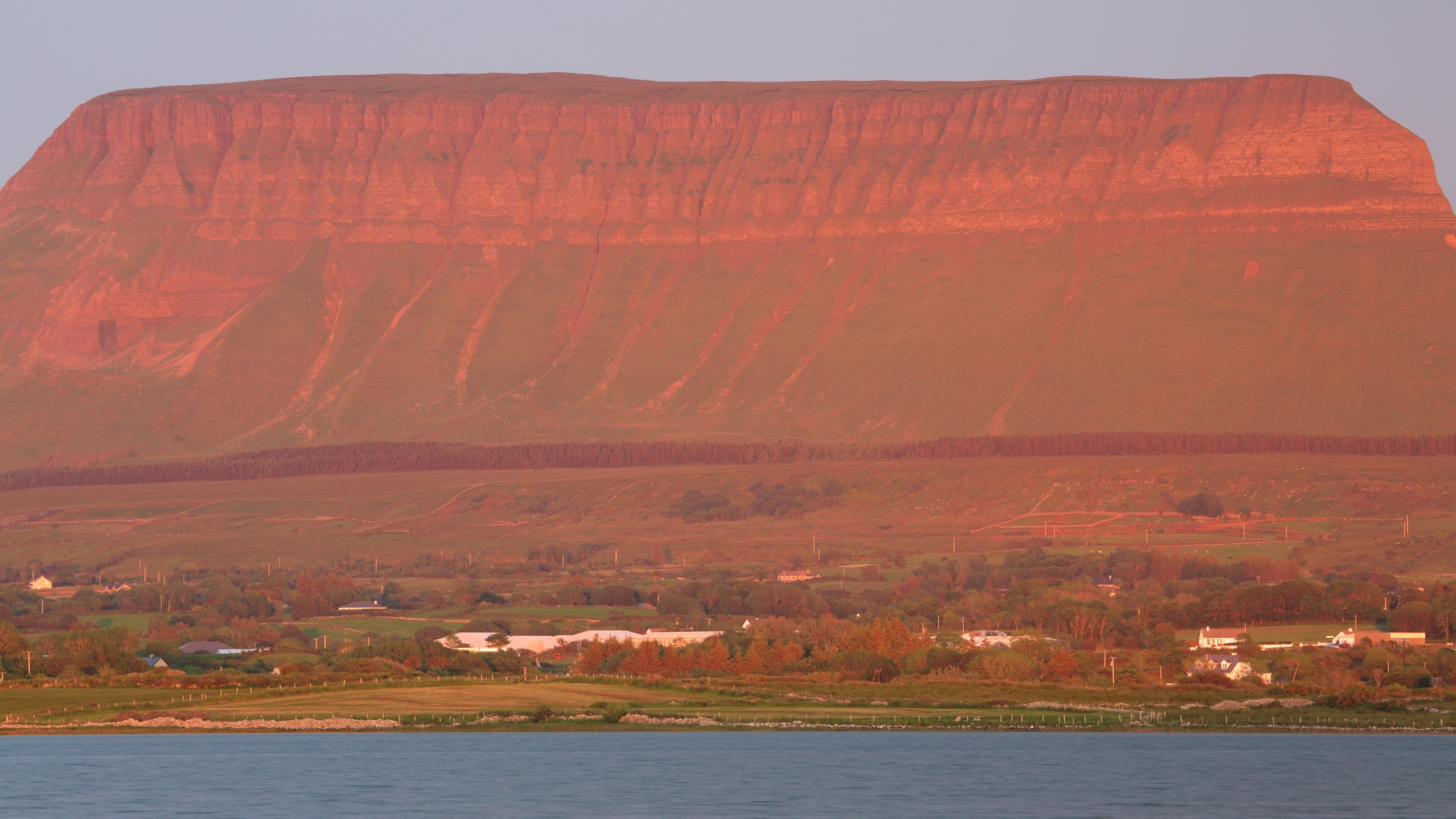 Ben Bulben showing mountains, a river or creek and a sunset