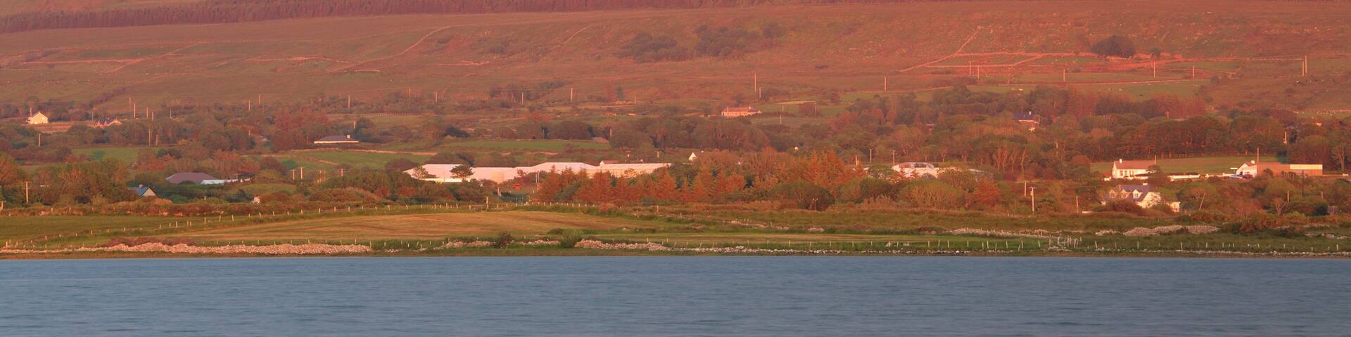 Ben Bulben which includes mountains, a river or creek and a sunset