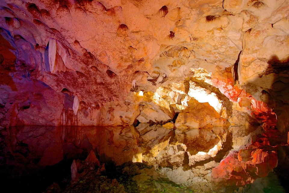 A cave with colorful rock formations and a central circular opening.