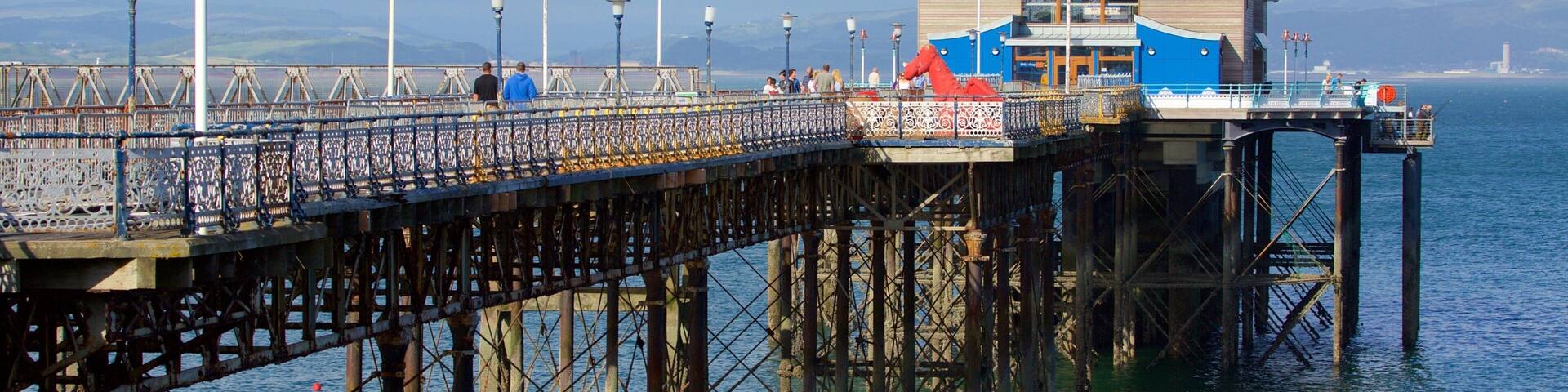 A pier with a lifeboat station and a large wooden building.