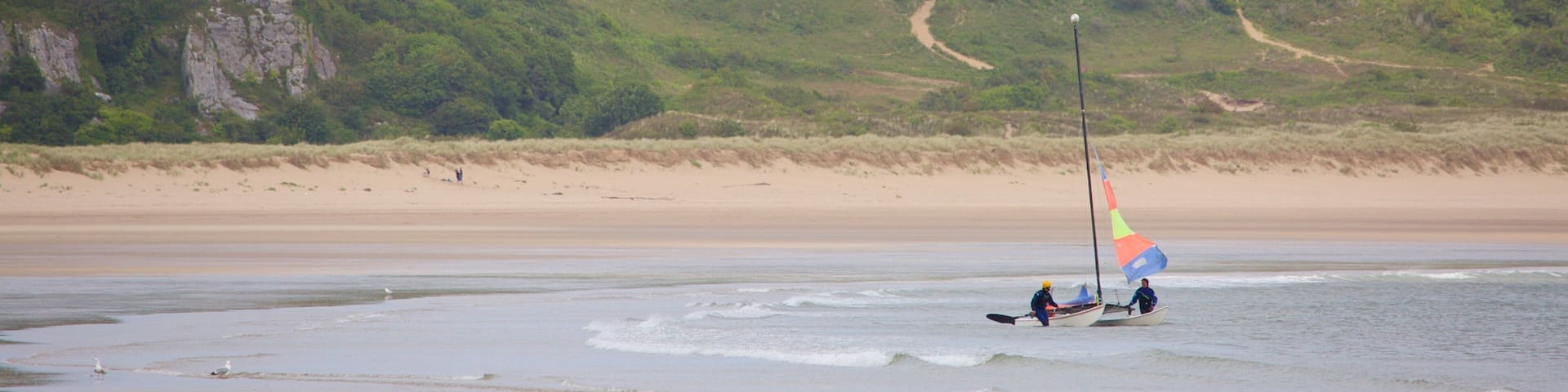 Oxwich Bay Beach featuring a bay or harbor and a beach