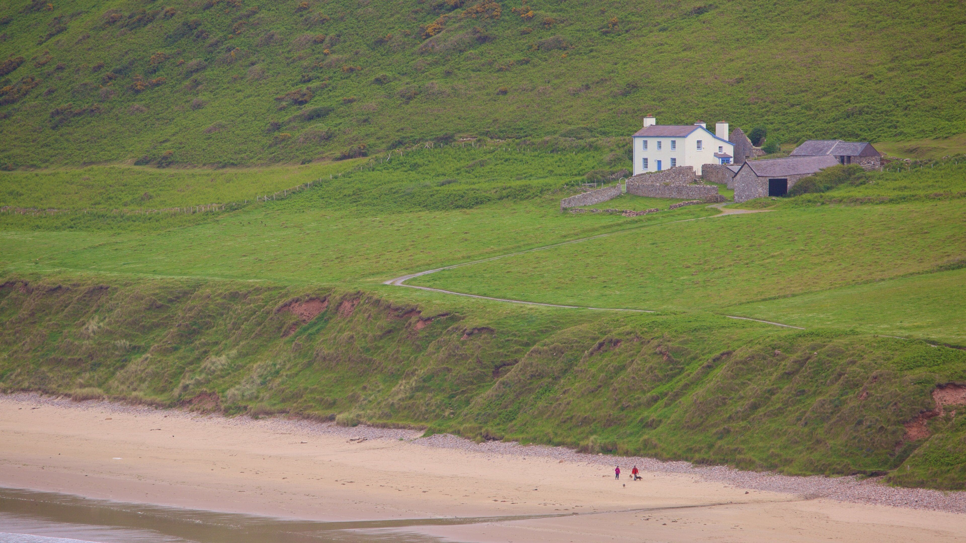 Rhossili Beach featuring a sandy beach, farmland and a house