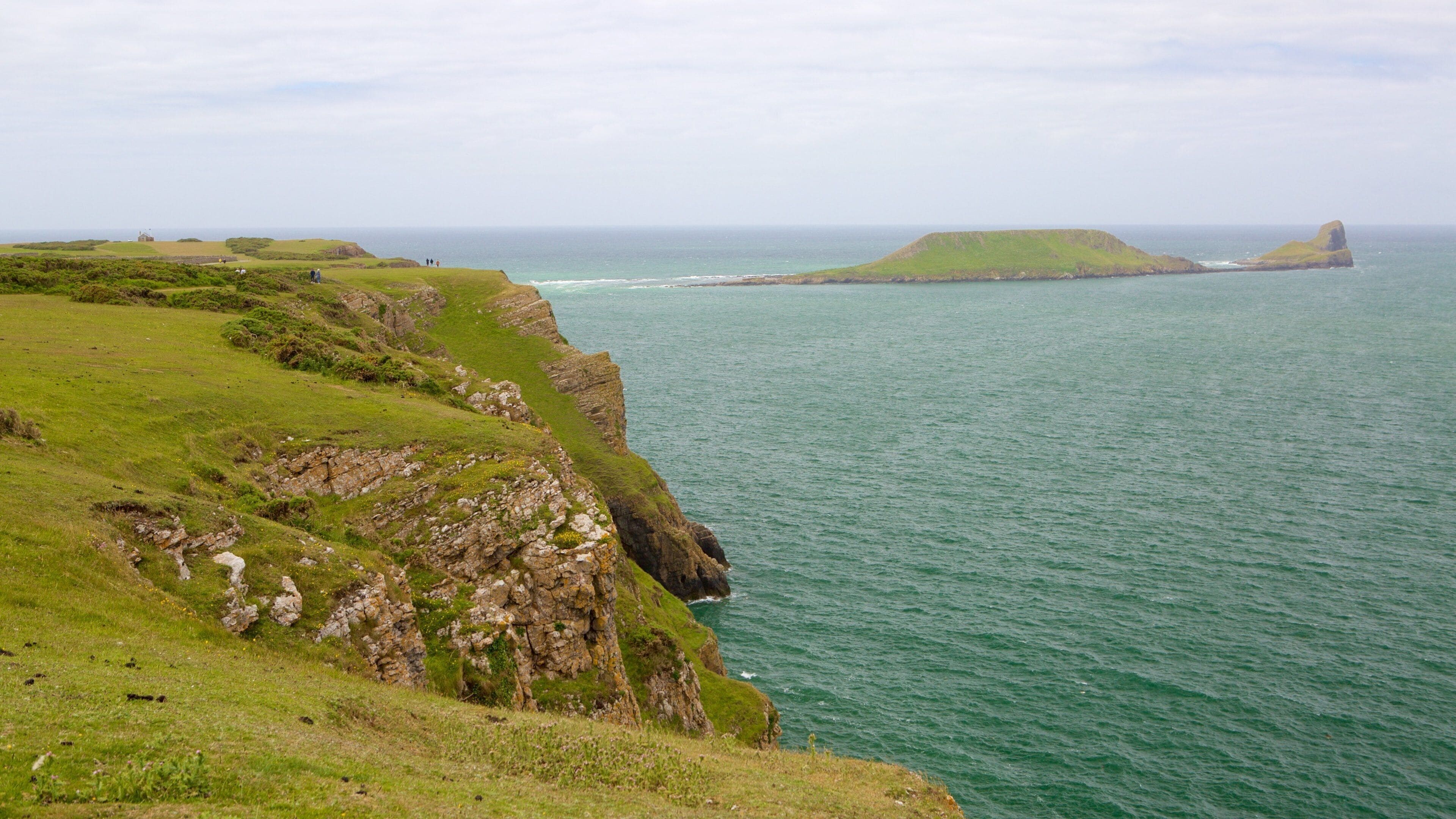 Rhossili Beach which includes farmland and rugged coastline