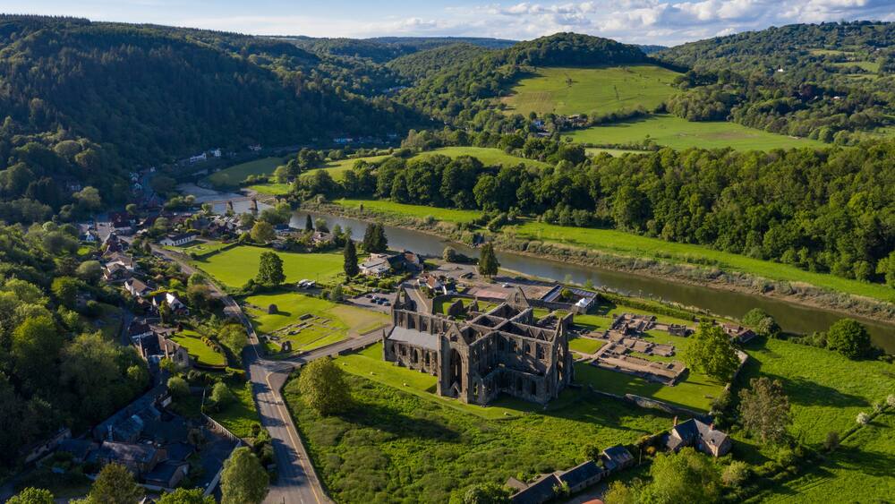 Aerial panoramic view of the ruins of Tintern Abbey, a Cistercian monastry located by the river Wye in South Wales, UK