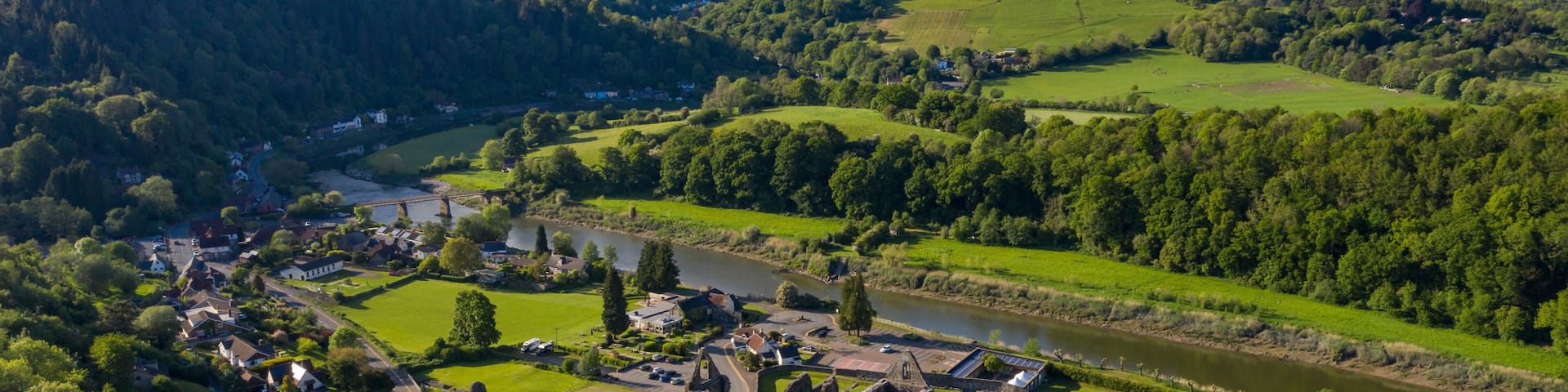 Aerial panoramic view of the ruins of Tintern Abbey, a Cistercian monastry located by the river Wye in South Wales, UK