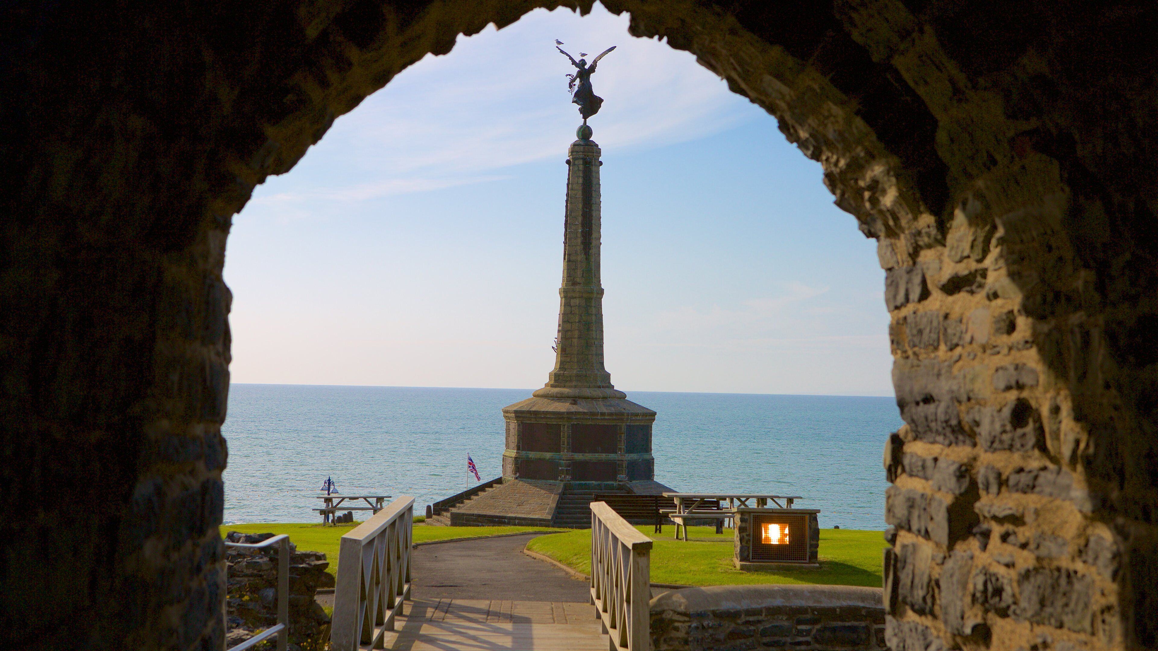 Castillo de Aberystwyth mostrando elementos patrimoniales, vistas de una costa y una estatua o escultura