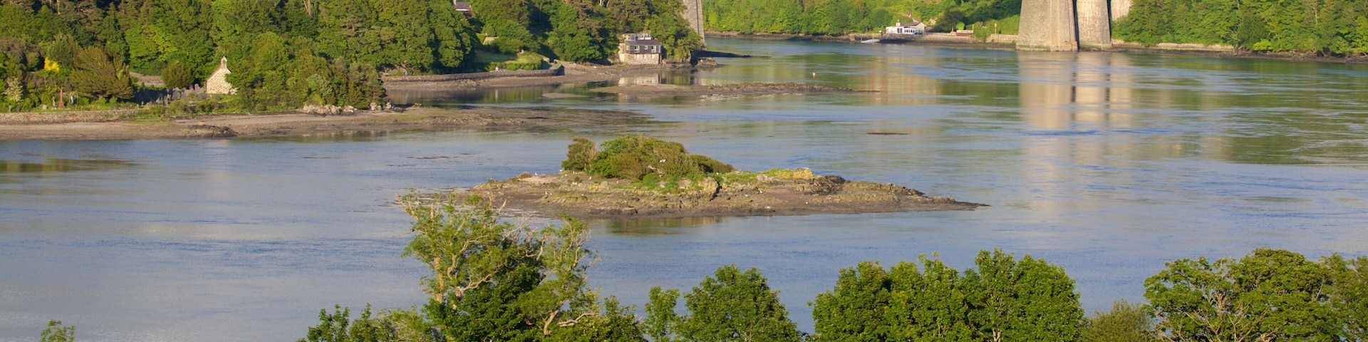 Menai Bridge showing a bridge, farmland and a river or creek