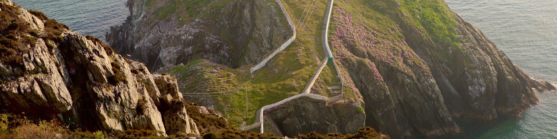 South Stack Lighthouse featuring a lighthouse, rocky coastline and general coastal views