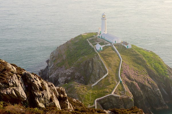 South Stack Lighthouse featuring a lighthouse, rocky coastline and general coastal views
