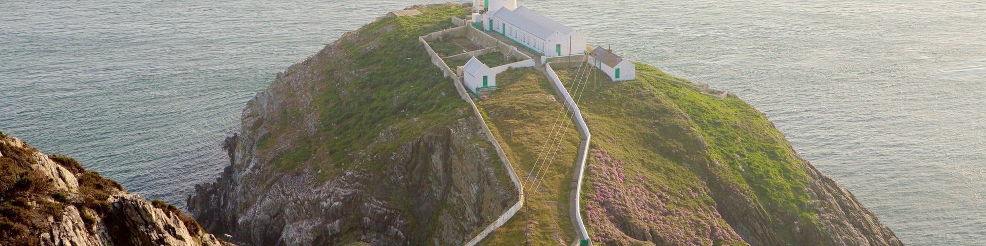 South Stack Lighthouse featuring a lighthouse, rocky coastline and general coastal views