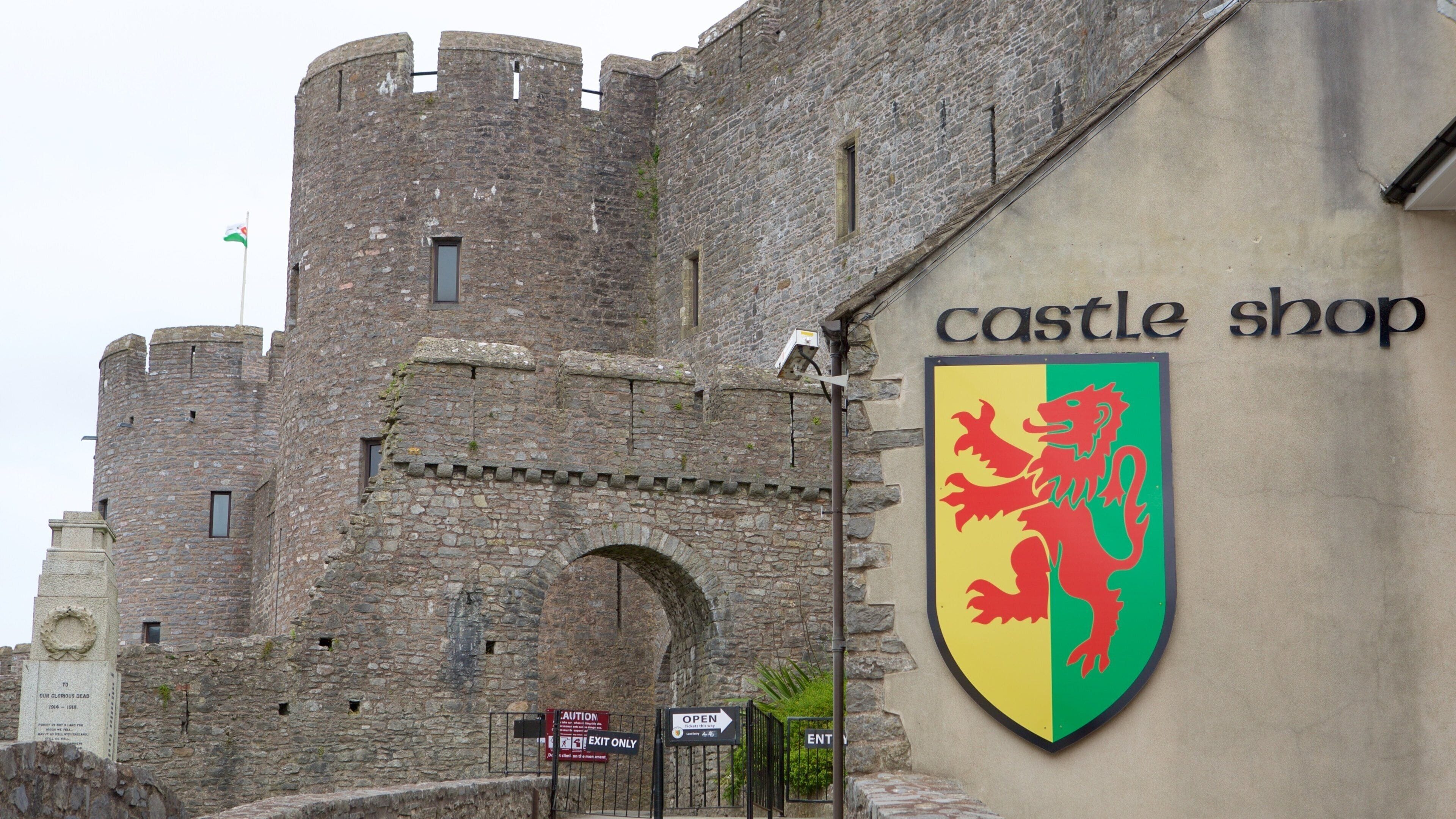 Pembroke Castle featuring signage and a castle