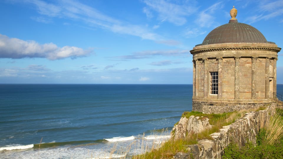 A coastal stone structure with a dome, overlooking the sea.