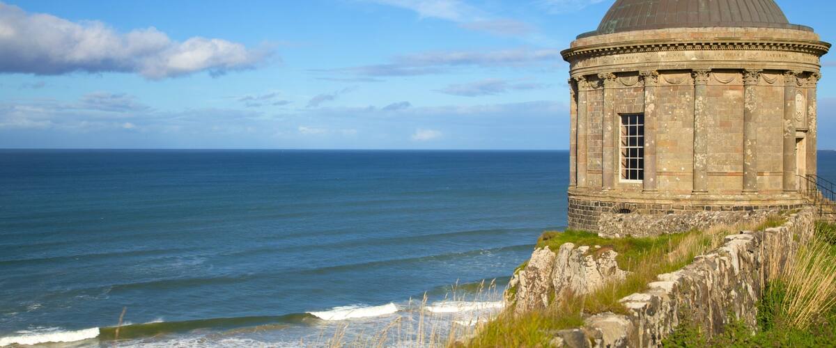 A coastal stone structure with a dome, overlooking the sea.