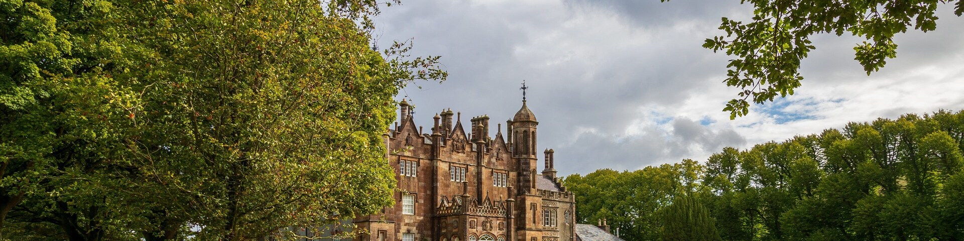 Glenarm Castle showing a park, a castle and heritage architecture