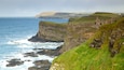 Dunluce Castle which includes landscape views and rocky coastline
