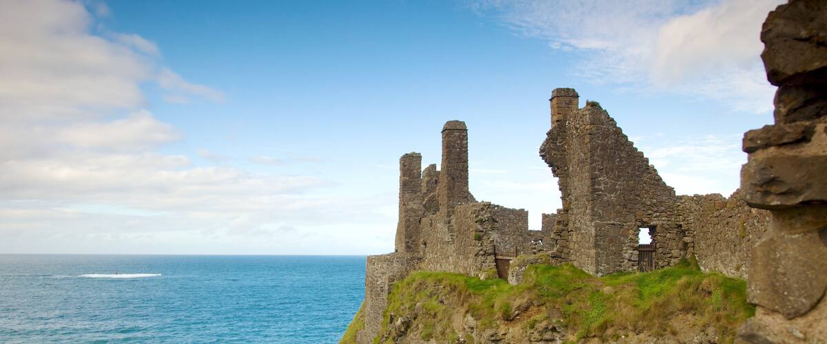 Dunluce Castle which includes general coastal views, building ruins and heritage elements