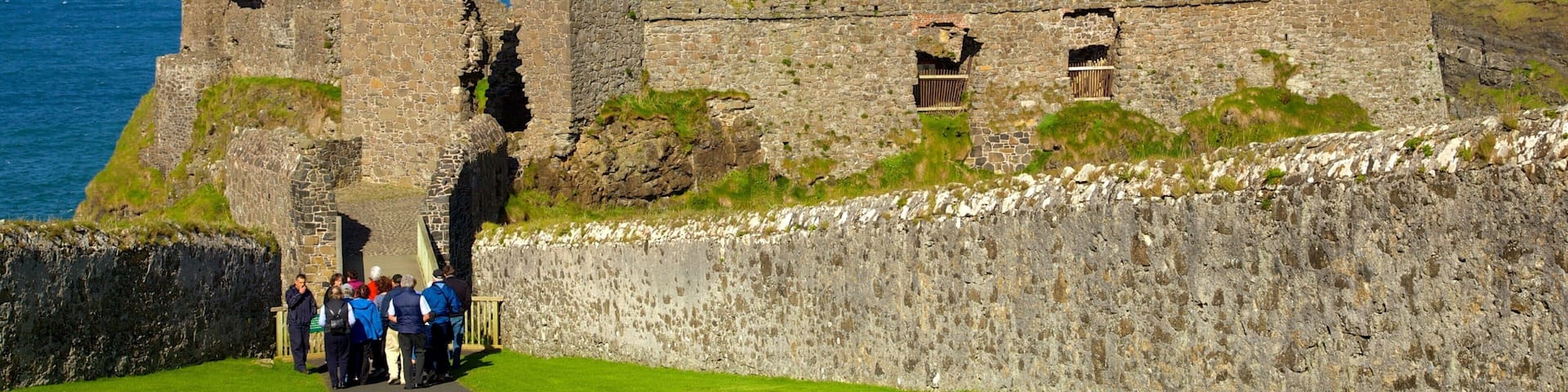 Dunluce Castle which includes heritage elements and a ruin as well as a small group of people