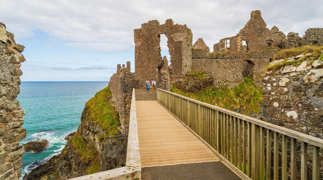 Dunluce Castle featuring general coastal views, building ruins and heritage elements