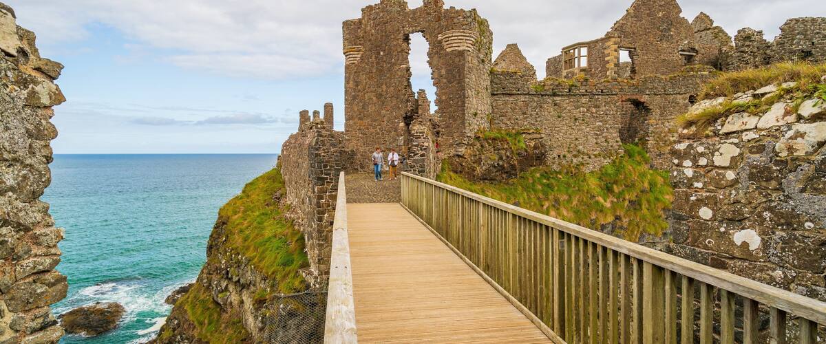 Dunluce Castle featuring general coastal views, building ruins and heritage elements