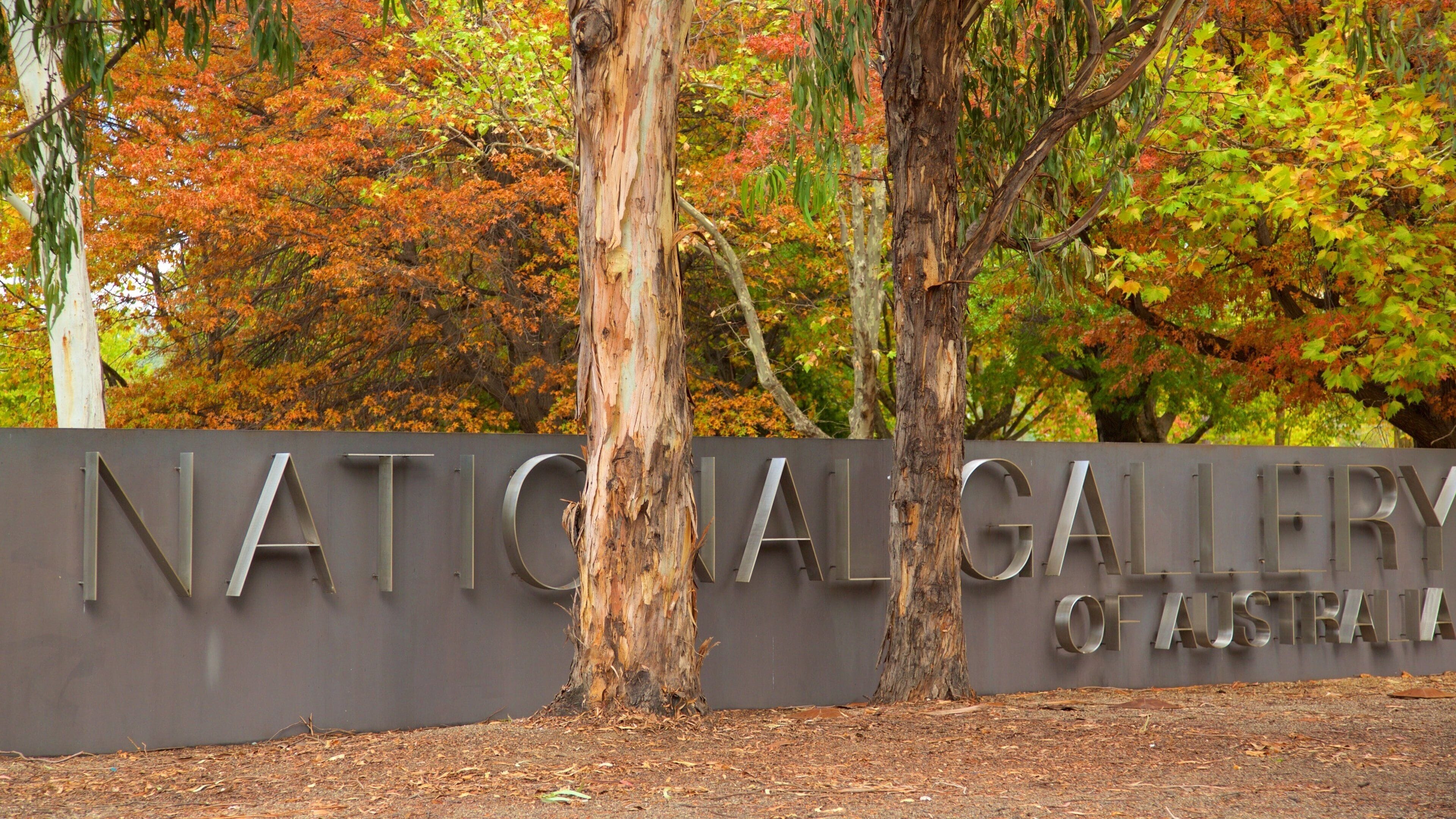 A sign for the National Gallery of Australia with trees in the background.