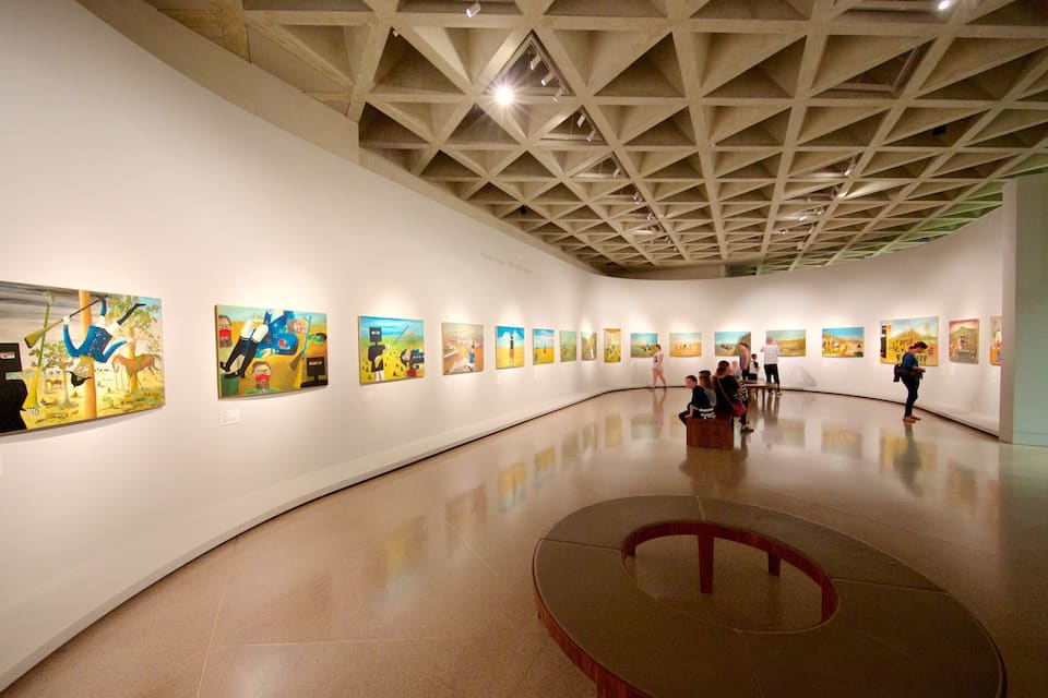 An art gallery with a high ceiling and a central circular platform.