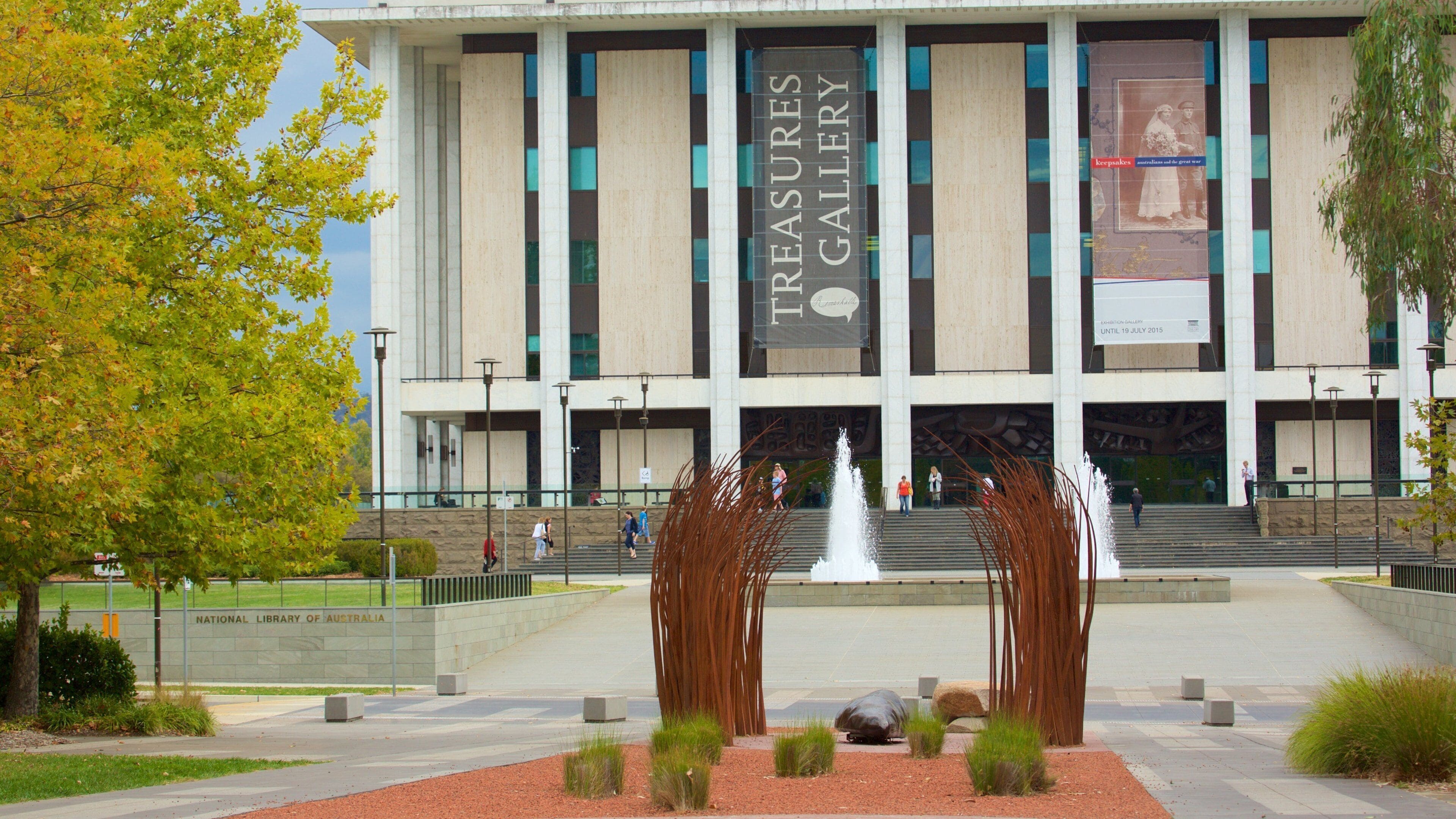 A building with a sign reading "Treasures Gallery" and a fountain in front.