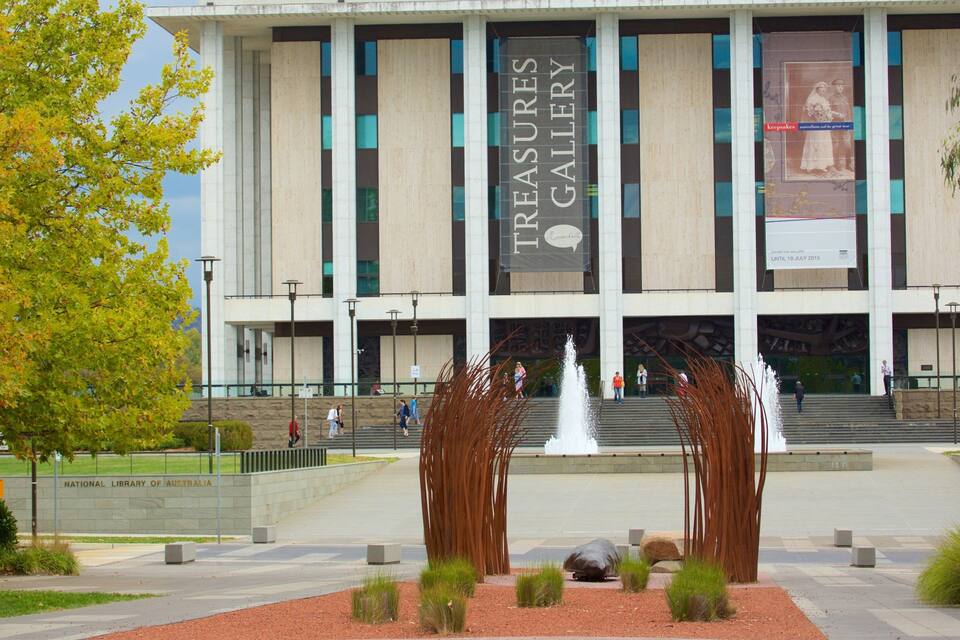 A building with a sign reading "Treasures Gallery" and a fountain in front.