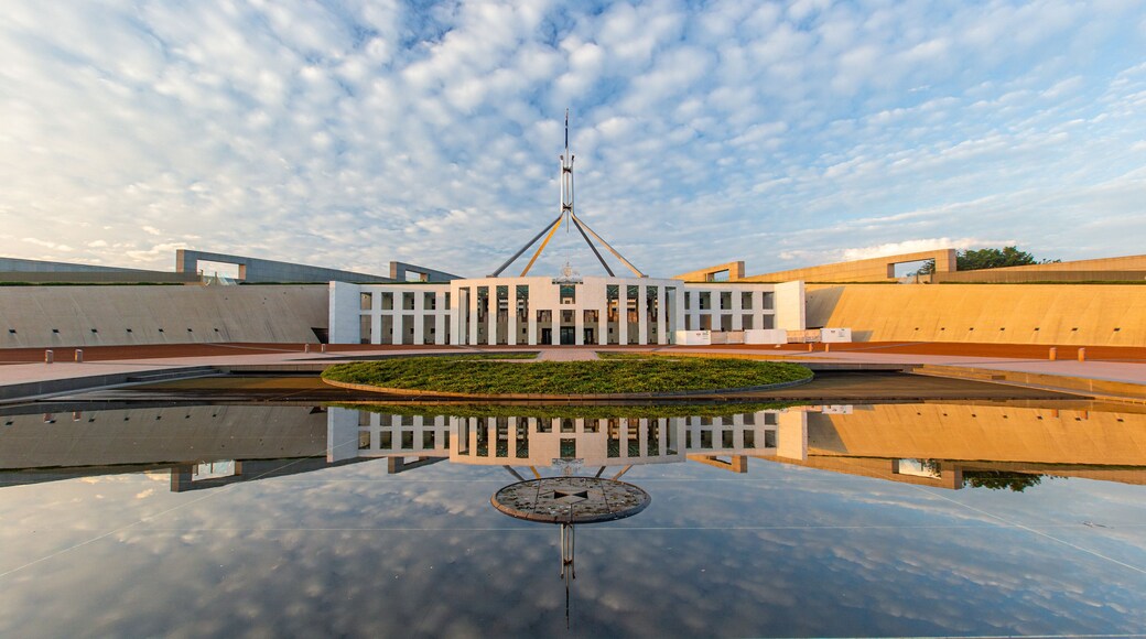 Parliament House which includes a sunset and an administrative buidling