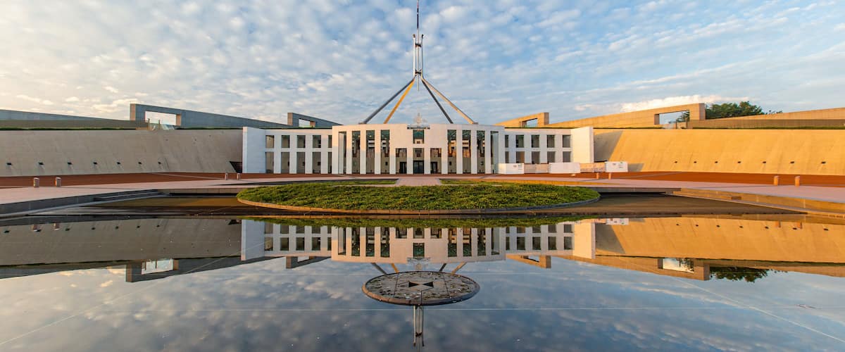 Parliament House which includes a sunset and an administrative buidling