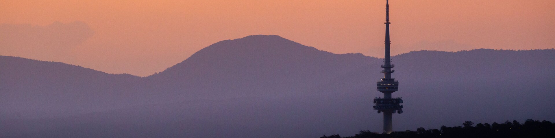 Telstra Tower featuring a sunset and landscape views