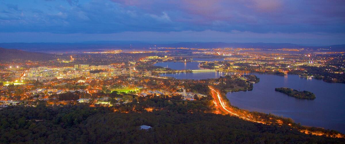 Telstra Tower which includes night scenes, a city and a lake or waterhole