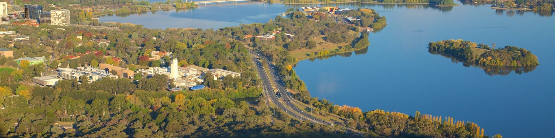 Telstra Tower featuring a lake or waterhole, landscape views and a city