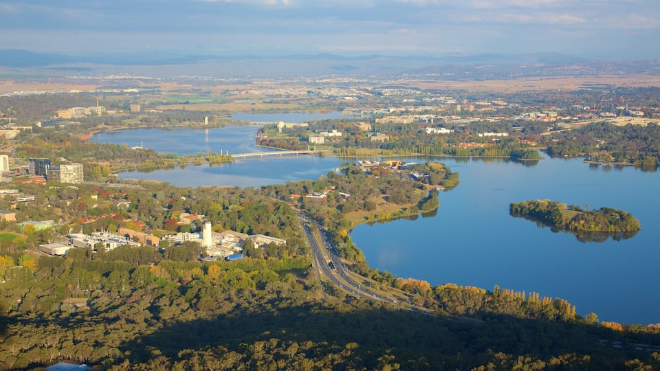 Telstra Tower featuring a lake or waterhole, landscape views and a city