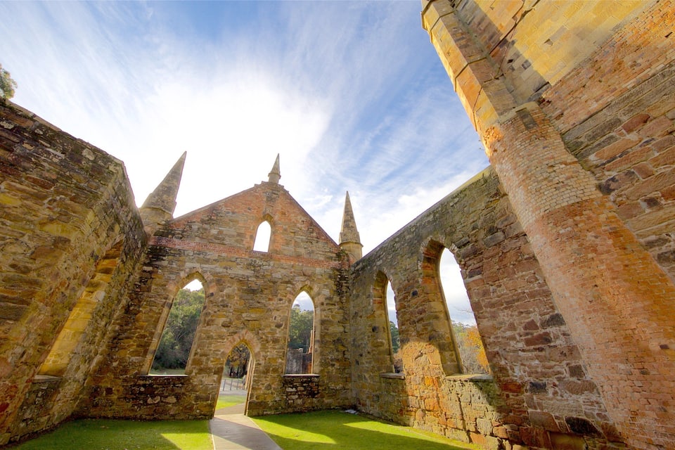 An ancient stone structure with arched doorways and a central tower.