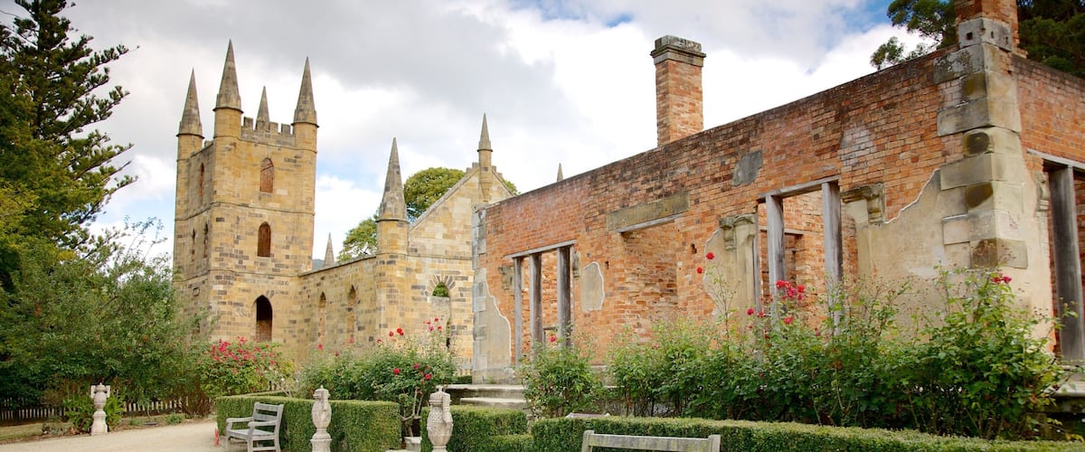 A historic stone church with multiple spires and a brick building with arched windows.