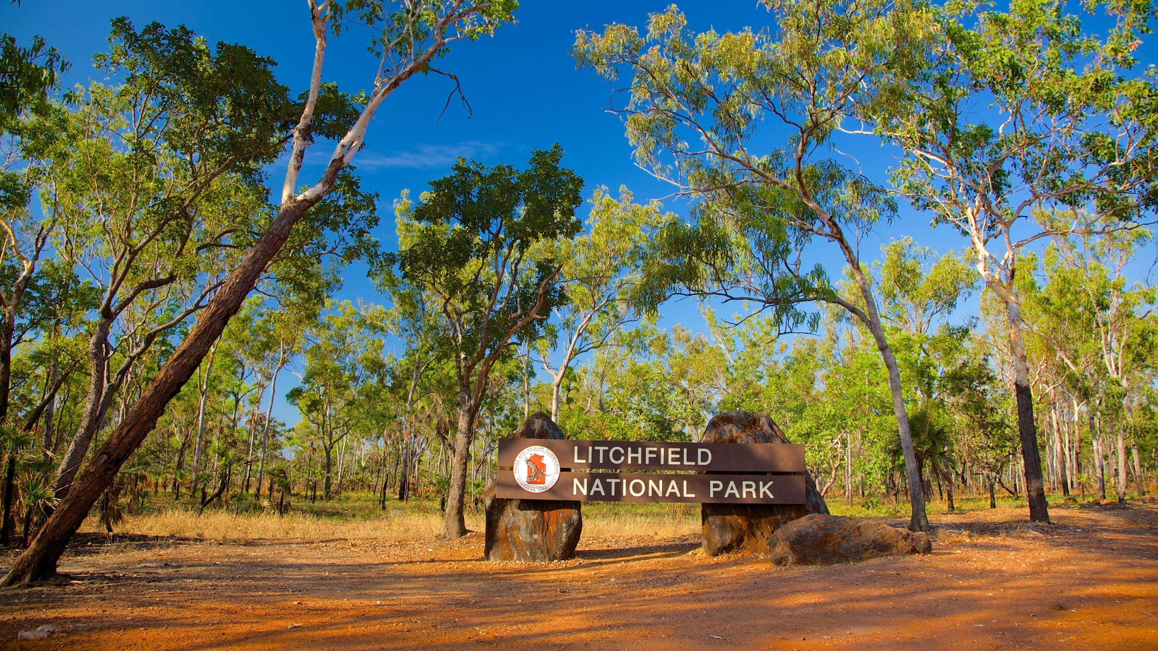 A sign for Litchfield National Park surrounded by trees.