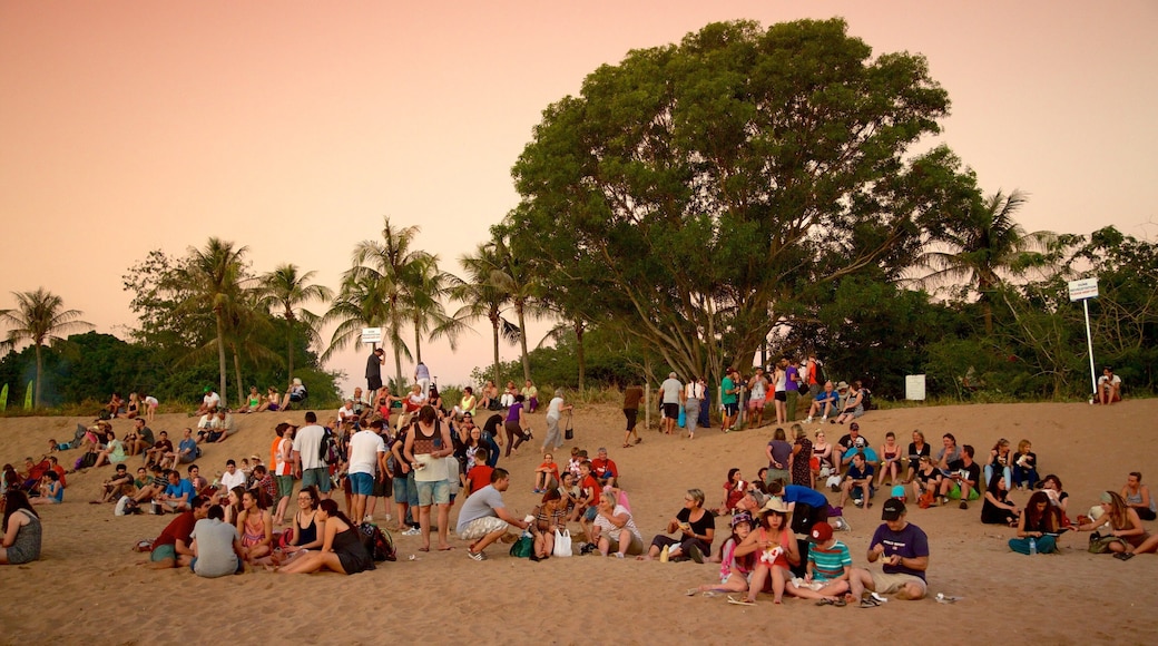 Mindil Beach showing a sunset and a beach as well as a large group of people
