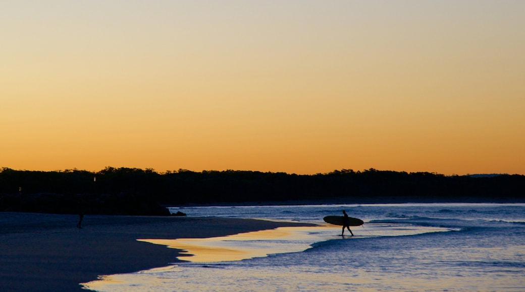 Noosa Beach which includes a beach, a sunset and surfing