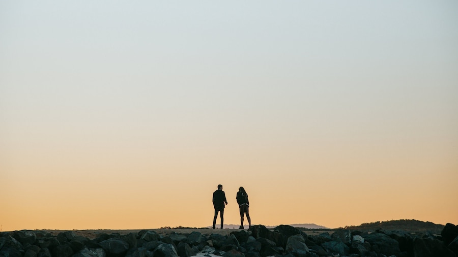 Noosa Beach which includes a sunset as well as a couple