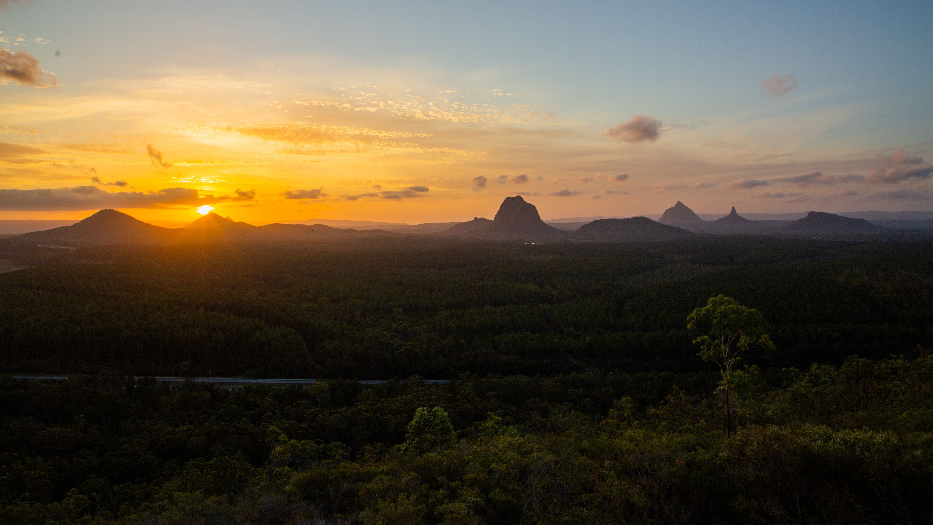Glasshouse Mountains National Park featuring tranquil scenes, landscape views and a sunset