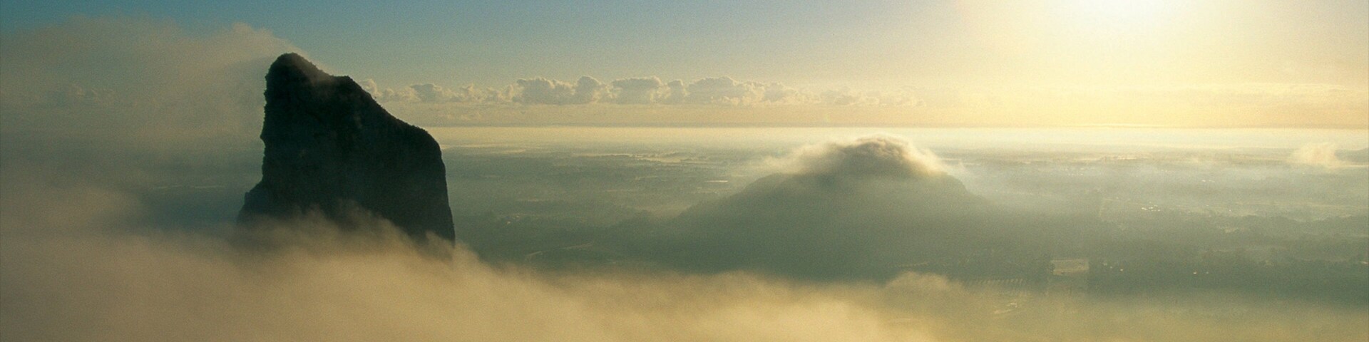 Glasshouse Mountains National Park featuring mist or fog, mountains and landscape views
