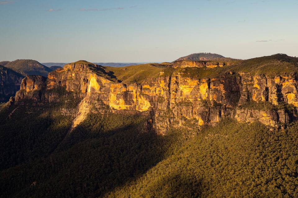 A canyon with steep cliffs and dense forest.