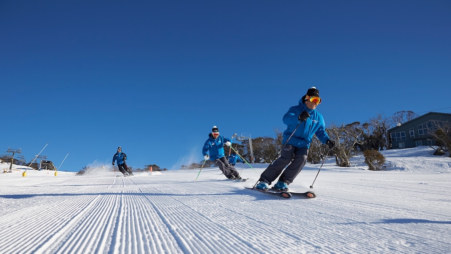 Perisher Ski Resort showing snow and snow skiing as well as a small group of people
