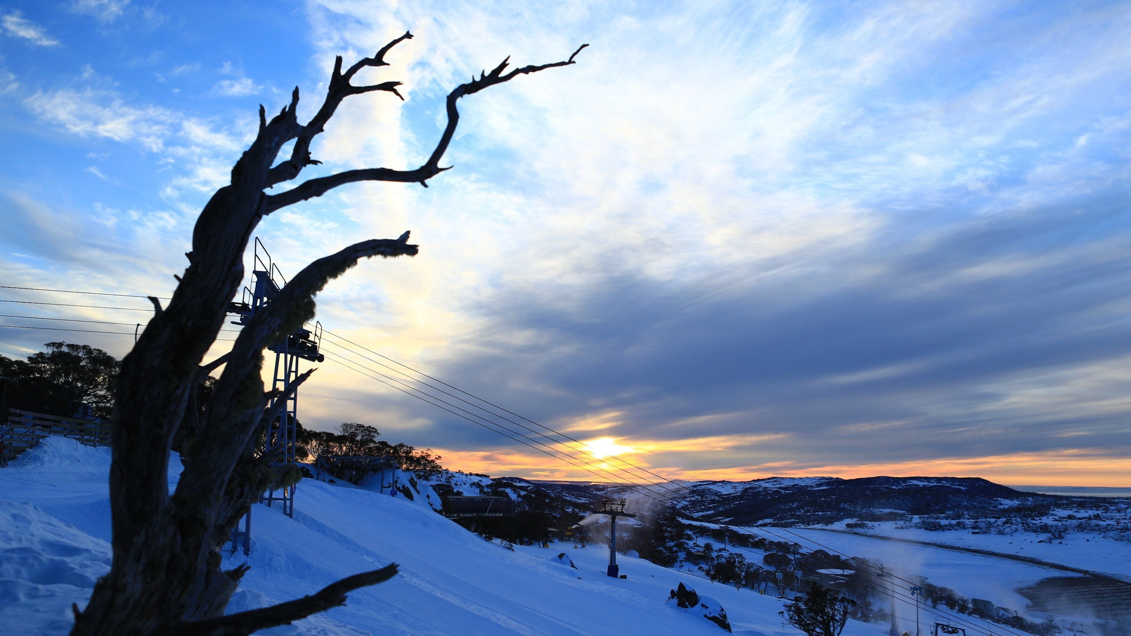 Perisher Ski Resort which includes snow, landscape views and a sunset