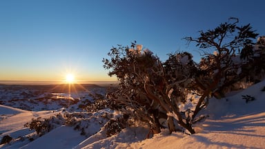 Perisher Ski Resort which includes landscape views, a sunset and snow