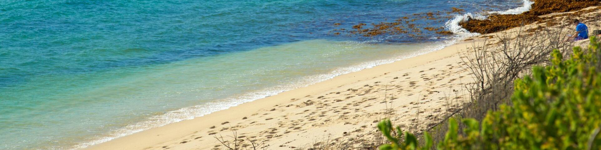 Prevelly Beach which includes a bay or harbor, general coastal views and a beach