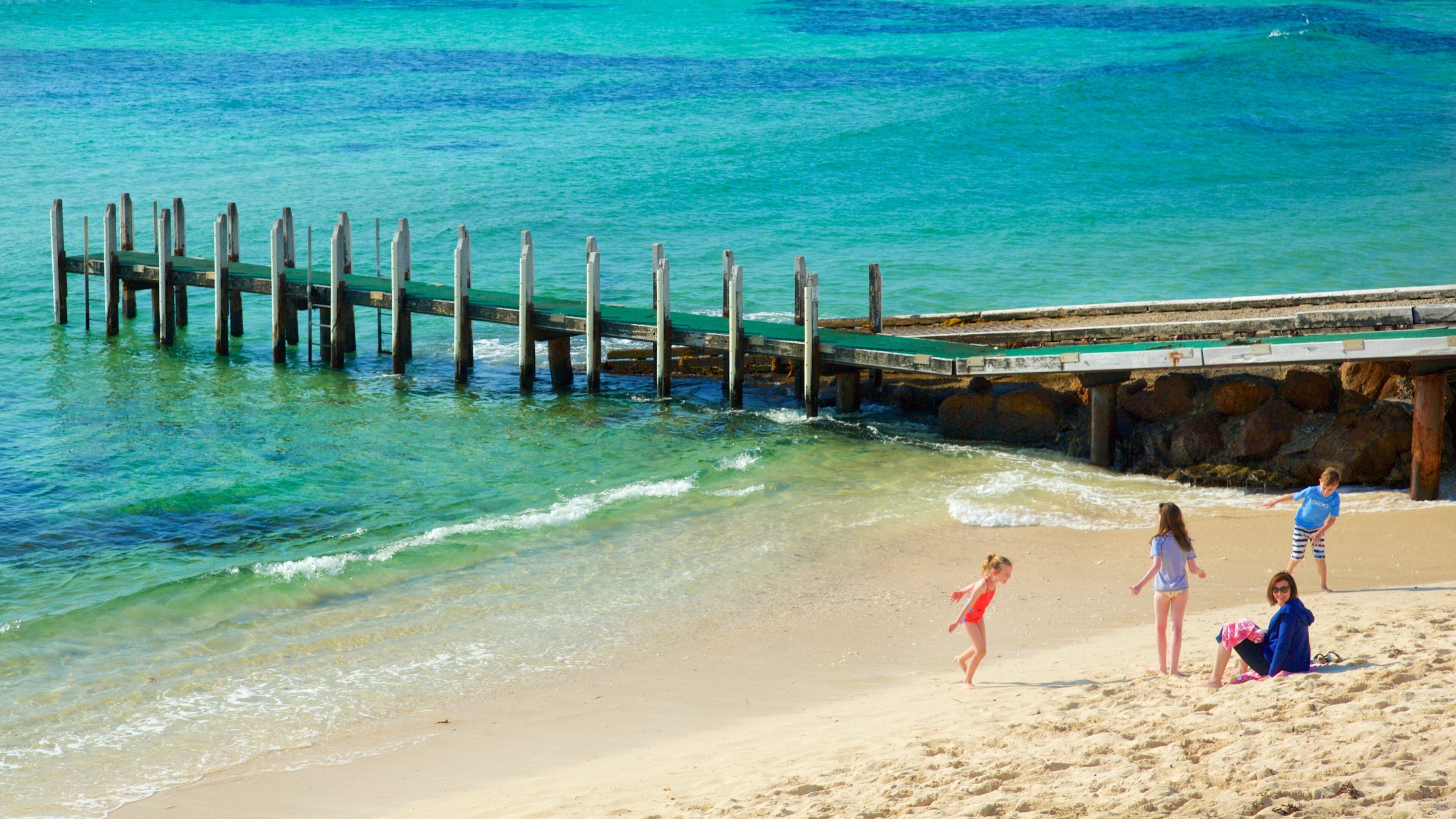 Prevelly Beach which includes a sandy beach and a bay or harbour as well as a family
