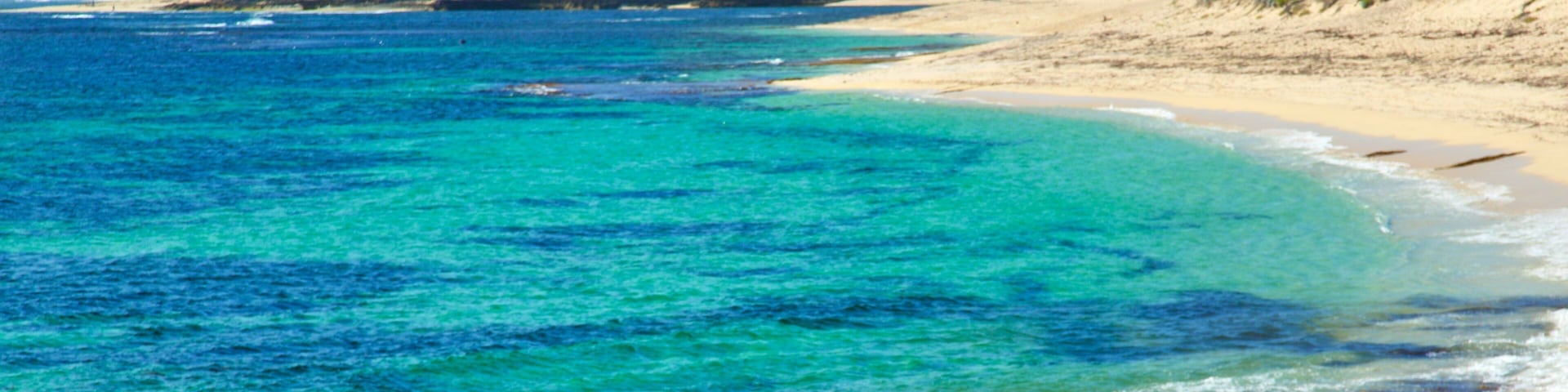 Prevelly Beach which includes a sandy beach, general coastal views and a bay or harbour